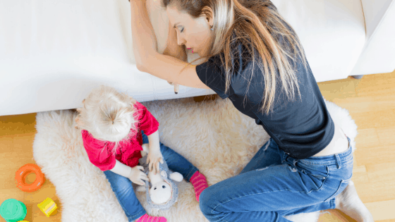 mom exhausted sleeping on couch next to toddler