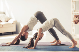 mom daughter doing yoga